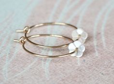 "Gold Filled Hoop Earrings, Tiny White Mother of Pearl Flower Hoop Earrings, Gold Hoop Earrings, Gold Earrings, Flower Hoops, Bridal Earrings, Gift for Her, Romantic Earrings, Feminine Earrings, Small Hoops, Dainty Earrings, MOP Earrings Adorable, feminine and lightweight 14k gold filled hoop earrings with the sweetest and tiniest carved white mother of pearl flowers. D E T A I L S: => Metal Type - 14k Gold Filled => Hoop size - Approx. 2 cm in diameter => Length - Approx 2 cm / 0.78\" Delicate Flower Charm Hoop Earrings, Dainty Hoop Earrings With Flower Charm, Delicate Hoop Jewelry With Flower Charm, Dainty Hoop Jewelry With Flower Charm, Minimalist Rose Gold Flower Earrings, Delicate Hoop Earrings With Flower Charm, Dainty Hoop Flower Earrings Gift, Delicate Hoop Earrings With Flower Charm For Gift, Dainty Flower-shaped Hypoallergenic Hoop Earrings