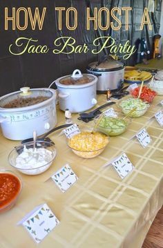 a table topped with lots of food next to a sign that says how to host a taco bar party