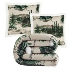 three pillows and two blankets with trees on them