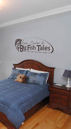 there is a bed with blue sheets and pillows in the room that says big fish tales