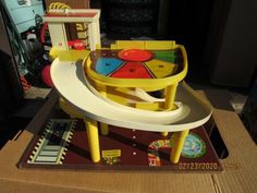 a child's toy table and chair sitting on top of a cardboard box