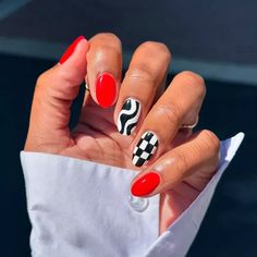 A red manicure with wavy and checkerboard accent nails Pink And Red Stripe Nails, Fun Diy Nails, Nail Ideas Checkered, Nail Inspo Checkered, Funky Short Nails Art Designs, Funky Red Nails, Checkard Nails Art, Simple Red And Black Nails, Black And White Checkered Nails