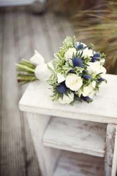 a bridal bouquet sitting on top of a wooden table