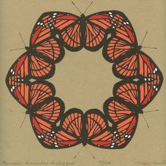 an orange and black butterfly circle on brown paper