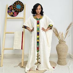 This stunning free-size Ethiopian dress features vibrant color designs, celebrating the beauty of cultural fashion. Designed for everyday elegance, it offers comfort and style, perfect for any occasion. Embrace tradition with a modern twist in this chic Habesha Kemis. Key Features: Cultural Heritage: Adorned with exquisite handwoven details that honor Ethiopia's rich traditions. Flattering Design: The flowing silhouette ensures you look stunning at weddings, festivals, or any event where you want to shine. Ethical Craftsmanship: Handmade by skilled Ethiopian artisans, embracing tradition while making a bold fashion statement. Care Instructions: For best results, we recommend gentle hand washing. Shipping Information: Processing Time: 10 days  Delivery: Shipping usually takes 3 to 5 days if Cultural Dress, Dress For Everyday, Cultural Fashion, Ethiopian Dress, Habesha Kemis, Everyday Elegance, Cultural Heritage, Bold Fashion, Ethiopia