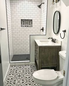 a white toilet sitting next to a walk in shower