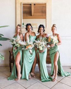 the bridesmaids are all wearing green dresses and holding bouquets in their hands