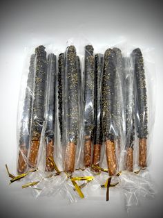 five wrapped hot dogs in plastic bags with gold sprinkles