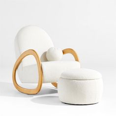 a white chair and ottoman sitting next to each other on a white surface with a wooden frame