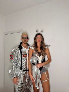 two people dressed in costumes standing next to each other