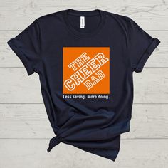 'The Cheer Dad-Less saving. More doing.' Tee! This shirt is a unisex fit. ---T-SHIRT FABRIC DETAILS--- 100% airlume combed and ringspun cotton Heather colors are 4.2 oz., 52% airlume combed and ringspun cotton, 48% polyester, 32 singles Heather Athletic is 90% airlume combed and ring-spun cotton, 10% polyester ---CARE INSTRUCTIONS--- Wash item inside out in cold water with like colors. Do not bleach. Do not dry clean. Do not iron directly over the design. ---DISCLAIMER--- Actual product colors m Cheer Tees Shirt Ideas, Allstar Cheer, Cheer Team Gifts, Sports Parent