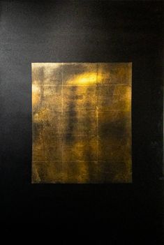 an abstract painting with gold paint in a black frame