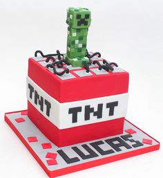 a cake made to look like the letter t on top of a block that says, that's mine