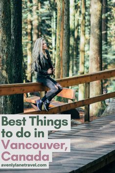 a woman sitting on top of a wooden bridge in the woods with her legs crossed