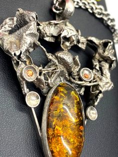 "UNIQUE AMBER PENDANT Hand-made Sterling Silver. Stones used: Amber, Garnet, Citrine. Height - 80mm, Width - 56mm. Unique Handcrafted One-of a-kind Design Pendant Each Piece of Jewelry in my Collection is Absolutely One of a Kind! When you start wearing a piece of my jewelry you will fall in love with it more and more each day and feel that good Energy and Love that I pass into it while creating this piece of Art. A piece of Art created for you to be inspired and love it through all your life. I Amber Gemstone, Amber Pendant, Amber Ring, Mismatched Earrings, Star Ring, Multi Stone, Stone Pendant, Stone Earrings, Long Earrings