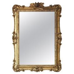 an ornate gold framed mirror against a white background