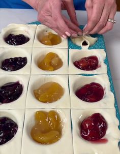 a person is making jelly squares on a table