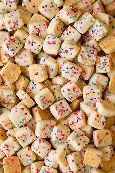 a pile of white and yellow marshmallows with colorful sprinkles