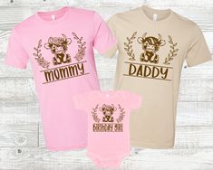 two baby onesuits with the words mommy and daddy printed on them in brown, pink and beige