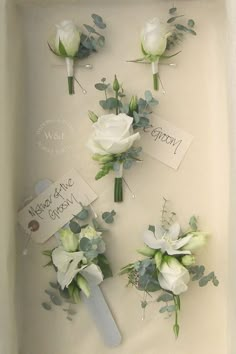 wedding boutions in a white box with greenery