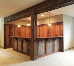 an empty room with wood paneling and lights