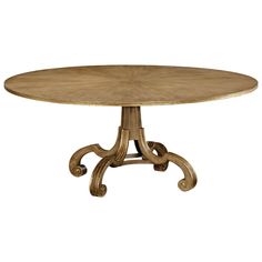 a round wooden table with an ornate design on the top and base, against a white background