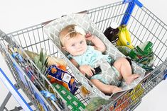 a small child sitting in a shopping cart