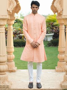 This stunning peach sherwani set is perfect for your next event. It features front buttons fastening, and a mandarin collar. The peach sherwani is made of georgette fabric and threadwork details with butter crepe lining. It is paired with a white cotton stretch churidar pants. An ideal outfit for traditional & special events.

Size Chart For Men





	
	
					Men's Size Chart
		

		
		
						
				Size Chart For Men
				Custom Size Measurement Guide
			
			
				
				
				Custom Size Measurement G Lineart Embroidery, Peach Sherwani, Coat Set, Japanese Symbol, Georgette Fabric, Churidar, Mandarin Collar, Skirt Length, White Cotton