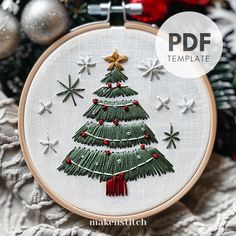 a cross stitch christmas tree on a white background