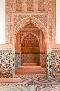 the inside of an ornate building with blue and white tiles on the walls, arches and doorways