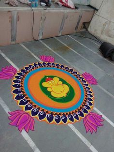 a colorful rangolite design on the ground in front of a counter