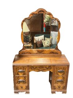 an antique wooden desk with mirror on top