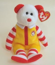 a white teddy bear with red and white stripes on it's body sitting down