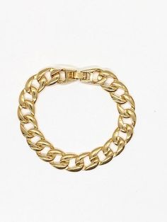 "Add a dose of tough-luxe glamour to after-dark looks with this golden curb-chain bracelet. ✤ Available in 14k Gold plated brass ✤ Chain size 10 mm wide ✤ Come in size 5.5, 6, 6.5, 7, 7.5 and 8 mm Please choose from drop down box ✤Watch Clasp-Curb Chain Push-release closure S I Z I N G Take a yarn or string wrap it around your wrist and cut it when the ends meet. Take the piece of yarn and measure it on a ruler. Let us know your size in a note and we will take care of the size for you. All purch Watch Clasp, Cuban Link Bracelet, Chunky Bracelet, Chunky Chain Necklaces, Big Hoop Earrings, Link Chain Bracelet, Family Necklace, Gold Cross Necklace, Chunky Bracelets