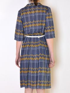 Cool vintage dress made of thinner fabric - navy blue with print of white grid and dots with yellow zig-zags. Collared. Half sleeves gathered on the shoulders. Flared, pleated midi-length skirt part. Belt loops. Belt not included. Era: 70's or, most likely unique, tailored piece Fabric: polyester Condition: very good Estimated size: L / XL (please, check the measurements) Measurements (measured flat, need to be doubled to get the circumference): Chest: 51cm / 20 inches Waist: 45 cm / 17,7 inches Retro Geometric Pattern Dress For Spring, Retro Dresses With Geometric Pattern For Spring, Retro Spring Dress With Geometric Pattern, Retro Short Sleeve Patterned Dress, Retro Patterned Dress With Short Sleeves, Navy Retro Dress For Work, Retro Patterned Short Sleeve Dress, Retro Navy Dress For Spring, Navy Retro Workwear Dress