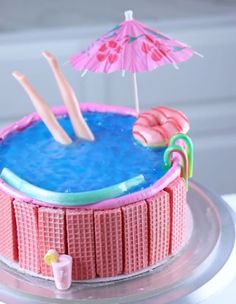 a cake decorated with pink flamingos and umbrellas