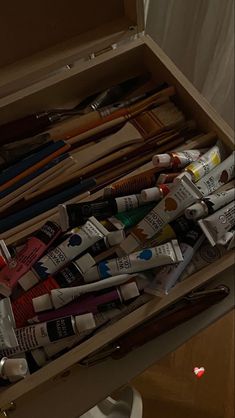 an open box filled with lots of different types of toothbrushes