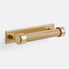 an image of a brass finish bathroom towel bar with round knobs on the end