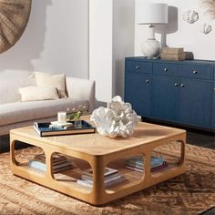 a living room with a couch, coffee table and bookshelf in the corner