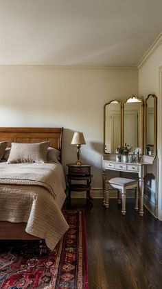 a bedroom with a bed, dresser and mirror in the corner next to a rug