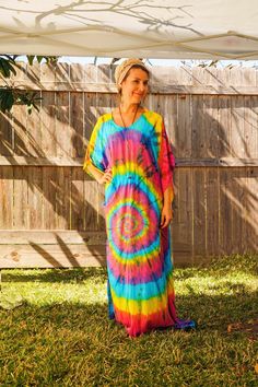 "Add a touch of unique style to your wardrobe with our Hand-Dyed Kaftan Dress! This stunning dress is made from 100% breathable and comfy rayon fabric, ensuring maximum comfort all day long. Using our unique method, each dress is carefully hand dyed, resulting in a one-of-a- kind masterpiece. The intricate patterns and vibrant colors make this dress a true work of art. The kaftan dress comes in a versatile one size fits most (M-3XL), making it extremely comfortable for a wide range of body types. With a bust measurement of up to 60\", you can feel confident that this dress will flatter your figure. The dress measures 55\" in length and 45\" in width, providing a loose and flowing fit that is both stylish and flattering. Featuring a trendy boat neck design and side slits, this slipover styl Multicolor Hippie Maxi Dress For Beach Cover-up, Multicolor Hippie Maxi Dress For Beach, Colorful Bohemian Maxi Dress For The Beach, Colorful Bohemian Maxi Dress For Beach, Bohemian Colorful Maxi Dress For Beach, Colorful Bohemian Beach Maxi Dress, Flowy Multicolor Beach Dress For Festival, Multicolor Flowy Beach Dress For Festival, Casual Tie Dye Maxi Dress For Beach