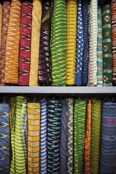 many different colored fabrics are stacked together