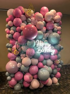 a bunch of balloons that are in the shape of a birthday cake with happy birthday written on it