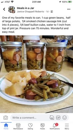 a white plate topped with green beans and pickles next to jars filled with food