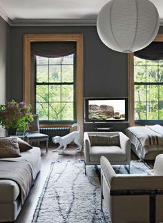 a living room filled with furniture and a flat screen tv