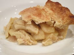 a close up of a pie on a plate with some food in it's middle