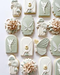 decorated cookies arranged in the shape of angel wings, flowers and other things on display