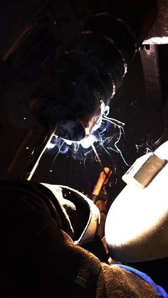 a person welding something in the dark