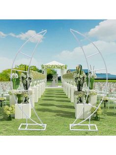 an outdoor wedding setup with white chairs and flowers