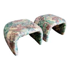 a pair of foot stools made out of upholstered fabric with flowers on them